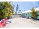 Spacious backyard surrounded by lush greenery, including palm trees, offers privacy and outdoor entertainment space at 1021 Estremadura Dr, Bradenton, FL 34209