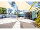 Spacious backyard featuring awning shades, a fire pit, and convenient access to the screened-in porch at 1021 Estremadura Dr, Bradenton, FL 34209