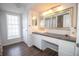 Bathroom featuring a decorative mirror, sink with white cabinets and dark countertops at 1021 Estremadura Dr, Bradenton, FL 34209