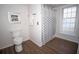 Bathroom featuring a modern toilet, patterned shower curtain, and wood floors at 1021 Estremadura Dr, Bradenton, FL 34209
