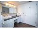 Bright bathroom featuring dark wood floors, and decorative mirror and white vanity at 1021 Estremadura Dr, Bradenton, FL 34209