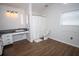 Bright bathroom features a wood floor, white cabinets, granite countertop, and shower with a white curtain at 1021 Estremadura Dr, Bradenton, FL 34209