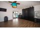 Spacious bedroom with wood flooring, dark-wood cabinets and a ceiling fan with eye-catching turquoise shade at 1021 Estremadura Dr, Bradenton, FL 34209