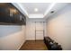 Walk-in closet with built-in storage solutions and wood floors at 1021 Estremadura Dr, Bradenton, FL 34209