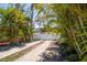 Long driveway offering ample parking, lined with lush landscaping and a secure privacy fence at 1021 Estremadura Dr, Bradenton, FL 34209