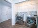 Laundry room with front-loading washer and dryer, built-in storage, and modern lighting for efficient chore management at 1021 Estremadura Dr, Bradenton, FL 34209