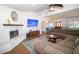 Comfortable living area with brick fireplace, large television, and plush seating at 1021 Estremadura Dr, Bradenton, FL 34209
