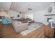 Bright living room features wood floors, ceiling fans, fireplace, and opens to kitchen and sliding doors at 1021 Estremadura Dr, Bradenton, FL 34209