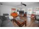 Comfortable living room with stylish furniture, wood floors, ceiling fan, and natural light creating inviting atmosphere at 1021 Estremadura Dr, Bradenton, FL 34209