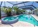 Screened pool with a spa, tropical landscaping, and a patio area at 1021 Estremadura Dr, Bradenton, FL 34209