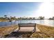 Water view and bench overlooking boats docked at marina with palm trees, and a clear sky at 1021 Estremadura Dr, Bradenton, FL 34209