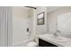 This bathroom features a shower and tub combo, granite countertop, and ample lighting at 10828 Gentle Current Way, Parrish, FL 34219