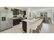 Modern kitchen with stainless steel appliances, granite countertops, and a breakfast bar overlooking the dining area at 10845 Gentle Current Way, Parrish, FL 34219
