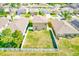 Aerial view of a fenced backyard with a well-maintained lawn and space for outdoor activities at 10944 Rainbow Pyrite Dr, Wimauma, FL 33598