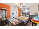 Cozy bedroom with a window offering natural light and a colorful patterned bedspread at 10944 Rainbow Pyrite Dr, Wimauma, FL 33598