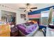 Bright bedroom with colorful walls, a ceiling fan, a large window, and a walk-in closet at 10944 Rainbow Pyrite Dr, Wimauma, FL 33598