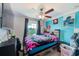 Vibrant bedroom with a ceiling fan, and a window offering a view of the outdoors at 10944 Rainbow Pyrite Dr, Wimauma, FL 33598