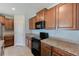 Kitchen showcases granite countertops, ample cabinet space, and modern black appliances at 10944 Rainbow Pyrite Dr, Wimauma, FL 33598