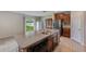 Large kitchen island with a stainless steel sink and a dishwasher, plus backyard view at 10944 Rainbow Pyrite Dr, Wimauma, FL 33598