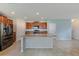 Open-concept kitchen features a large island, stainless steel appliances, and ample cabinet space at 10944 Rainbow Pyrite Dr, Wimauma, FL 33598