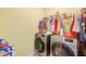 Laundry room with modern washer and dryer units, and storage for laundry supplies at 10944 Rainbow Pyrite Dr, Wimauma, FL 33598