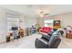 Comfortable living room with tile flooring, a ceiling fan, and plenty of natural light at 10944 Rainbow Pyrite Dr, Wimauma, FL 33598