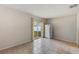 Bright room featuring tile floors, sliding glass doors and a white refrigerator at 10944 Rainbow Pyrite Dr, Wimauma, FL 33598