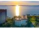 Stunning aerial view of the condo building with a glimpse of a bay at sunset at 1100 Imperial Dr # 403, Sarasota, FL 34236