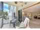 Comfortable tiled balcony with seating adjacent to the interior living area at 1100 Imperial Dr # 403, Sarasota, FL 34236