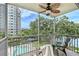 Relaxing screened balcony featuring stylish furniture, a ceiling fan, and stunning views of the pool and lush landscaping at 1100 Imperial Dr # 403, Sarasota, FL 34236
