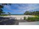 Picturesque beach area with modern wooden boardwalk, beach access, lush greenery, and serene ocean views at 1100 Imperial Dr # 403, Sarasota, FL 34236
