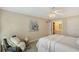 Calm bedroom featuring a white bed, chair with white pillows, soft natural light, and calming wall decor at 1100 Imperial Dr # 403, Sarasota, FL 34236