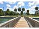 Beautiful community pier featuring a scenic walkway, lush landscaping, and a charming gazebo in a serene park setting at 1100 Imperial Dr # 403, Sarasota, FL 34236