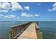 Picturesque waterfront property with a private wooden dock and stunning ocean views under a clear blue sky at 1100 Imperial Dr # 403, Sarasota, FL 34236