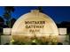 Whitaker Gateway Park entrance sign at nighttime with small plants in front at 1100 Imperial Dr # 403, Sarasota, FL 34236
