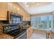 Modern kitchen with granite countertops, stainless steel appliances, and scenic views from the bright window at 1100 Imperial Dr # 403, Sarasota, FL 34236