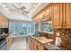 Bright kitchen featuring granite countertops, stainless steel appliances, a breakfast bar, and a scenic window view at 1100 Imperial Dr # 403, Sarasota, FL 34236