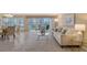 Bright living room with tile flooring, neutral paint, access to a balcony and view of the dining area at 1100 Imperial Dr # 403, Sarasota, FL 34236