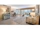 Open concept living and dining area featuring a balcony, tile floors, and neutral decor at 1100 Imperial Dr # 403, Sarasota, FL 34236