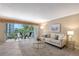 Bright and airy living room with access to a balcony and comfortable seating and decor at 1100 Imperial Dr # 403, Sarasota, FL 34236