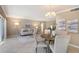 Bright living and dining area with tile flooring, neutral paint, and sliding doors to a balcony at 1100 Imperial Dr # 403, Sarasota, FL 34236
