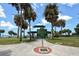 Pathway leads to a pavilion in the park featuring green grass and many tall palm trees at 1100 Imperial Dr # 403, Sarasota, FL 34236