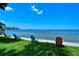 Relaxing waterfront view featuring colorful Adirondack chairs along the bay, perfect for enjoying the scenery at 1100 Imperial Dr # 403, Sarasota, FL 34236