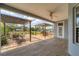 Open-air patio area with wood-look concrete and brick flooring, outdoor dining set, and covered outdoor grill at 1108 64Th Street E Ct, Bradenton, FL 34208
