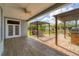 Open-air patio area with wood-look concrete and brick flooring, outdoor dining set, and covered outdoor grill at 1108 64Th Street E Ct, Bradenton, FL 34208