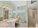 Bright bathroom features a vanity with a makeup area and a glass-enclosed shower at 1108 64Th Street E Ct, Bradenton, FL 34208
