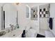 The bathroom features a black and white tiled shower, modern fixtures and bright natural light at 1108 64Th Street E Ct, Bradenton, FL 34208