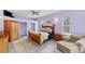 Comfortable bedroom with hardwood floors, a large bed, and a cozy reading chair at 1108 64Th Street E Ct, Bradenton, FL 34208