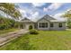 Well-maintained home with a manicured lawn, and a covered car portico. Large windows bring in natural light at 1108 64Th Street E Ct, Bradenton, FL 34208