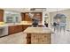 Spacious kitchen with wood cabinetry, stainless appliances, granite island, and open layout at 1108 64Th Street E Ct, Bradenton, FL 34208